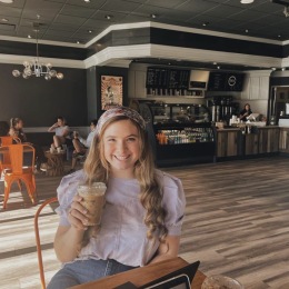 a girl in a coffee shop smiling