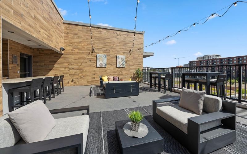 an outdoor patio with a couch and chairs