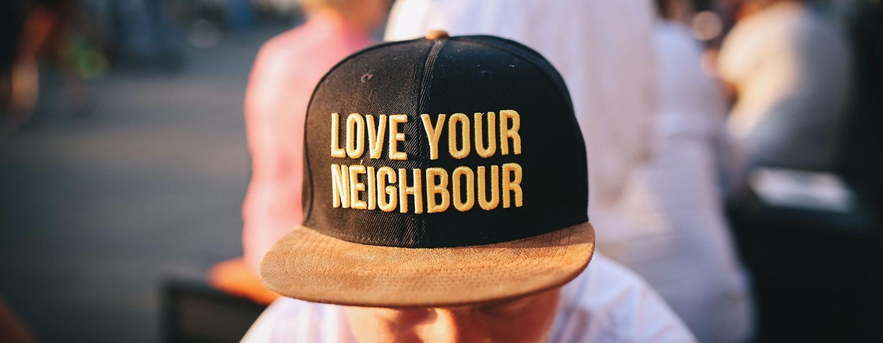 man with a baseball cap sitting outdoors